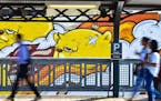 Chicago train riders walked past a mural by artist JC Rivera this month at the Paulina Brown Line "L" station on the city's North Side.