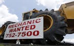 In this Tuesday, June 9, 2015 photo, a help wanted sign is posted at a tractor dealership in Ashland, Va.