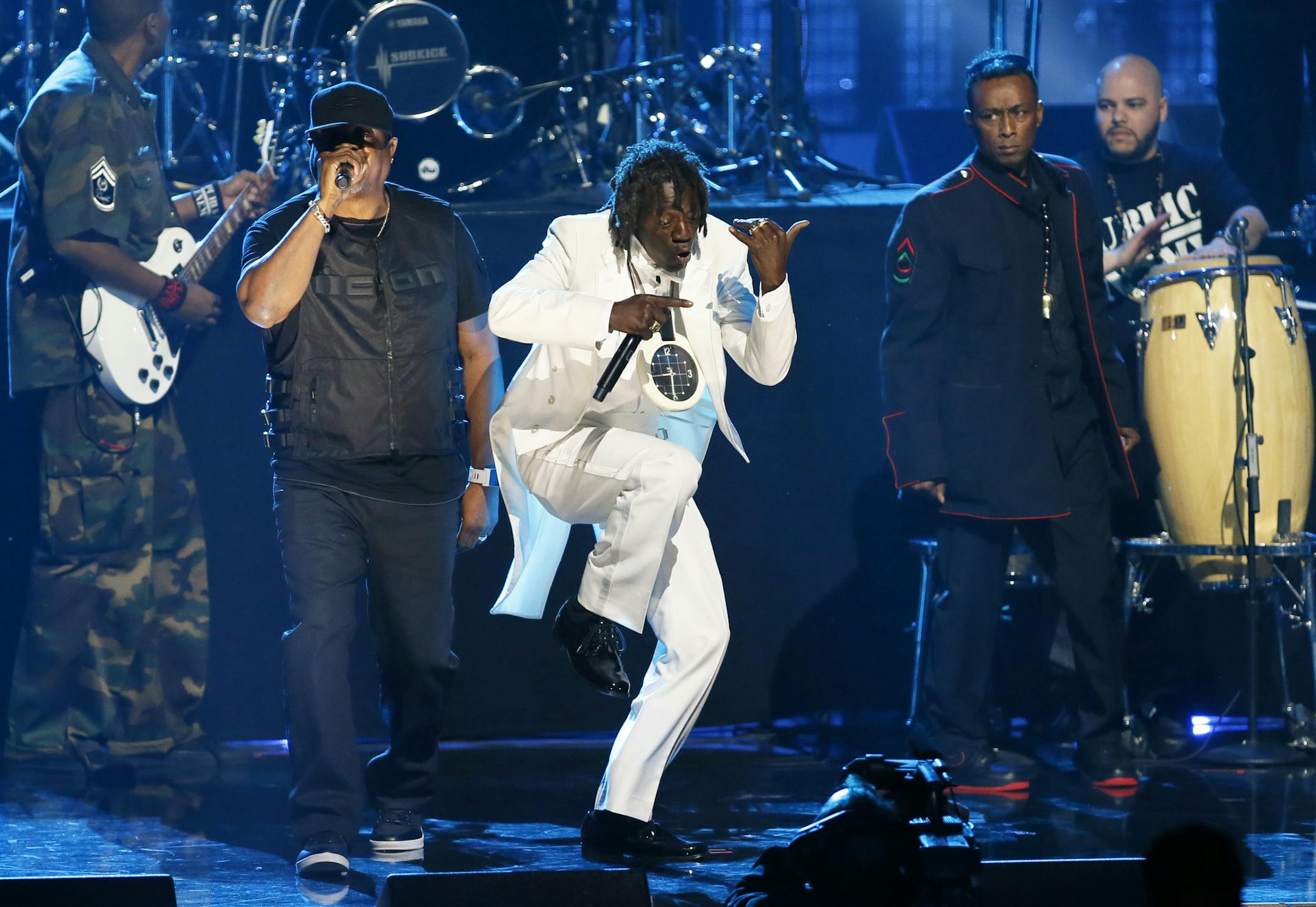 Inductees Chuck D, left, Flavor Flav, center, and Professor Griff, standing right, of Public Enemy perform during the Rock and Roll Hall of Fame Induction Ceremony at the Nokia Theatre on Thursday, April 18, 2013 in Los Angeles. (Photo by Danny Moloshok/Invision/AP)