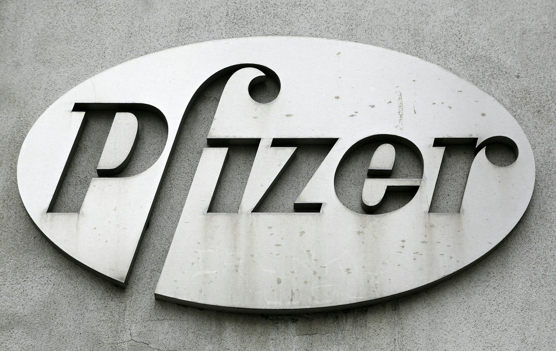 The Pfizer logo is displayed on the exterior of a former Pfizer factory, Sunday, May 4, 2014, in the Brooklyn borough of New York. The pharmaceutical giant said, Monday, May 5, 2014, that their first-quarter profit dropped 15 percent due to cheaper generic competition continuing to reduce sales of multiple medicines and the end of some partnerships promoting other companies‚Äô medicines. (AP Photo/Mark Lennihan) ORG XMIT: MIN2014050915211527