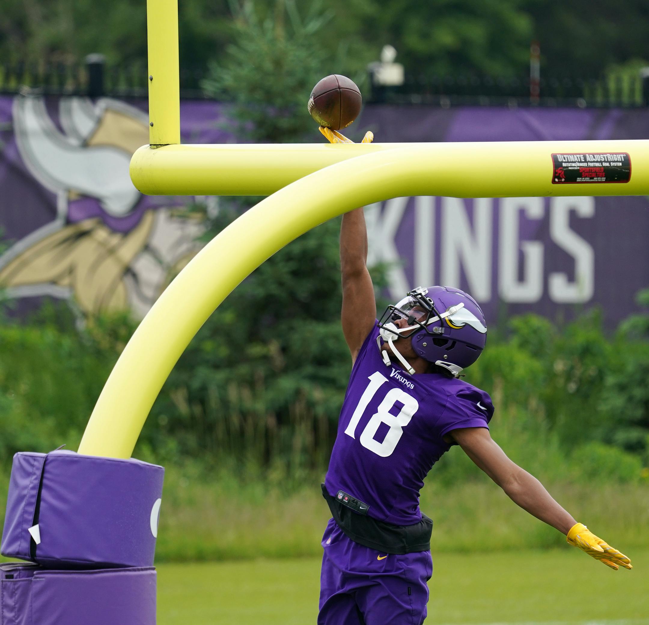 Minnesota Vikings wide receiver Justin Jefferson (18) tipped the ball over the goalpost after completing a pass.