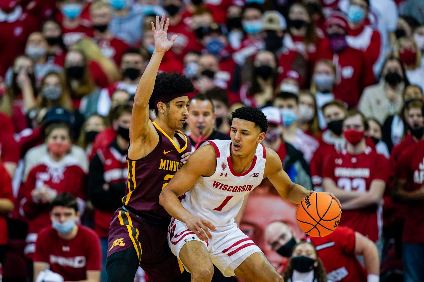 Wisconsin's Johnny Davis (1) and Minnesota's Eylijah Stephens (20) during the first half of an NCAA college basketball game Sunday, Jan. 30, 2022, in Madison, Wis. (AP Photo/Andy Manis)