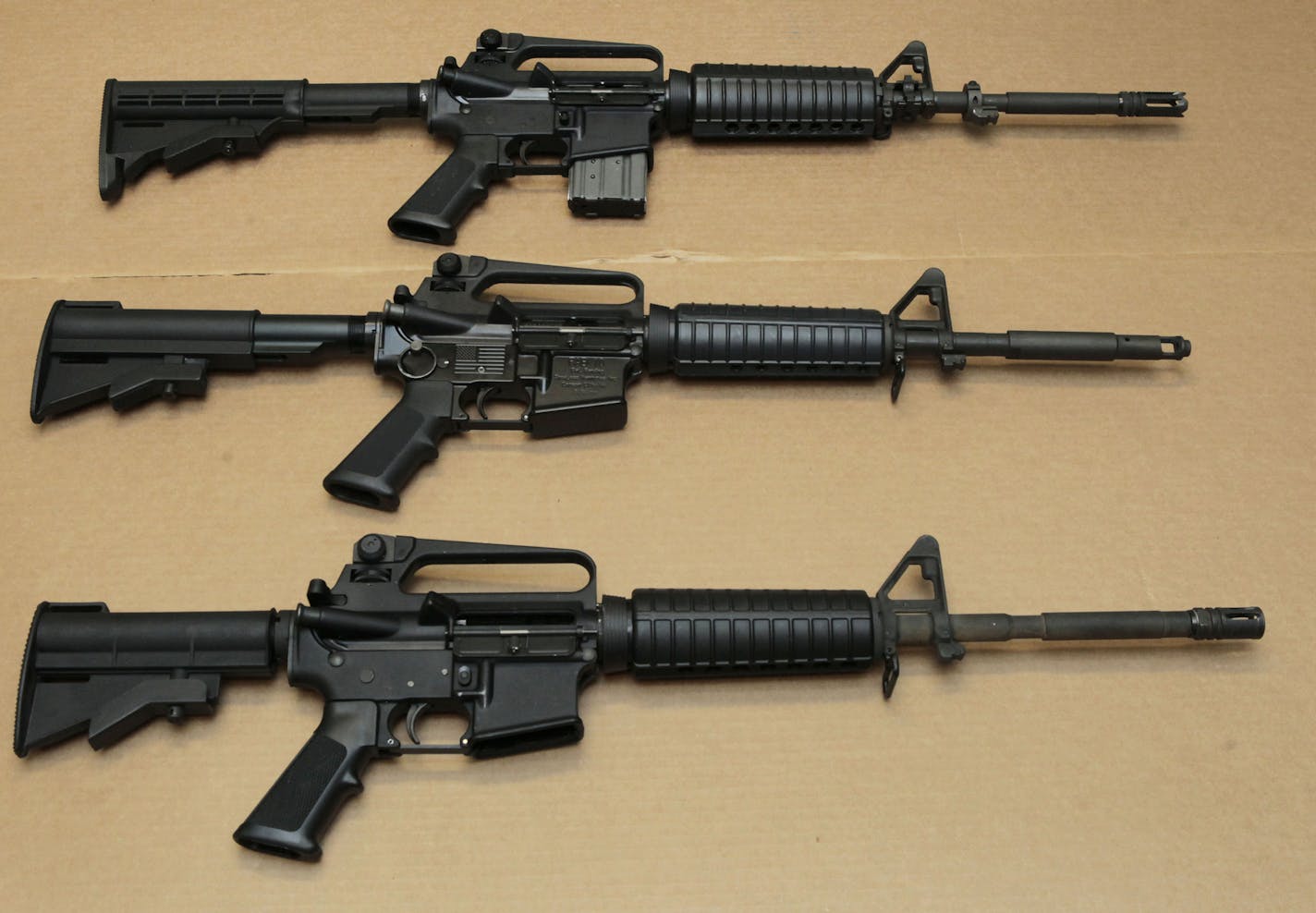 FILE -- In this Aug. 15, 2012 file photo, three variations of the AR-15 assault rifle are displayed at the California Department of Justice in Sacramento, Calif. While the guns look similar, the bottom version is illegal in California because of its quick reload capabilities. Omar Mateen used an AR-15 that he purchased legally when he killed 49 people in an Orlando nightclub over the weekend President Barack Obama and other gun control advocates have repeatedly called for reinstating a federal b