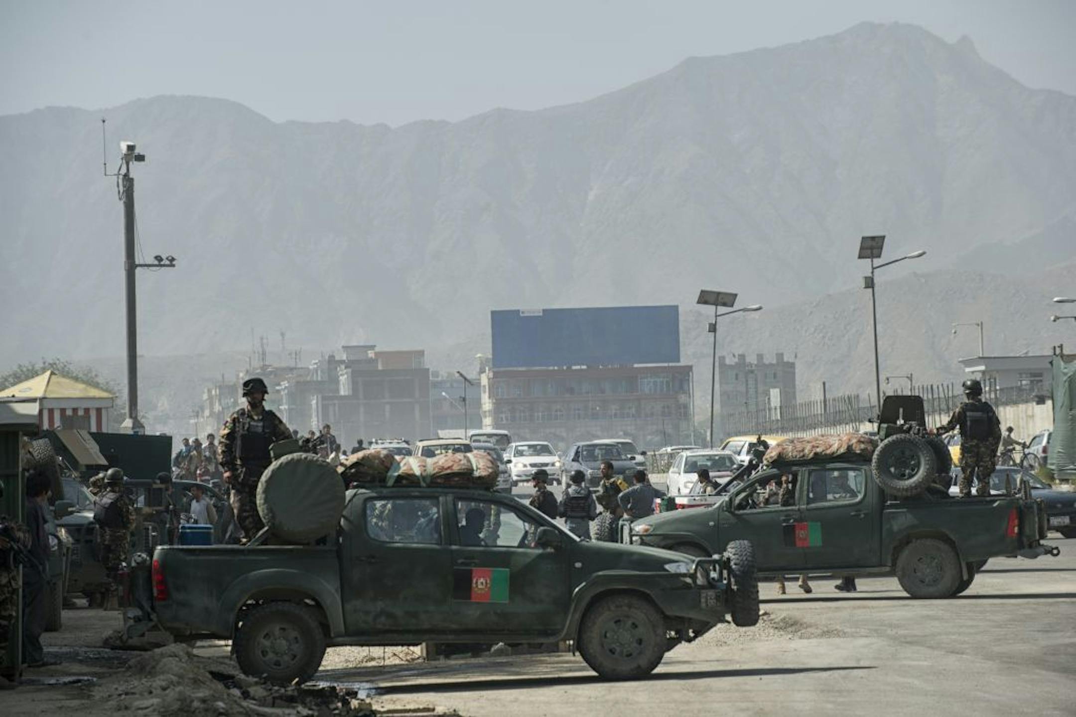Afghan security personnel guard a main gate to the presidential palace in Kabul, Afghanistan, June 25, 2013. At least four suicide bombers launched an attack on the compound early Tuesday morning, using land cruisers similar to those used by international soldiers here, fake badges and vehicle passes, which allowed at least one to get inside the heavily guarded area, according to Kabul's deputy police chief. (Lynsey Addario/The New York Times) -- NO SALES