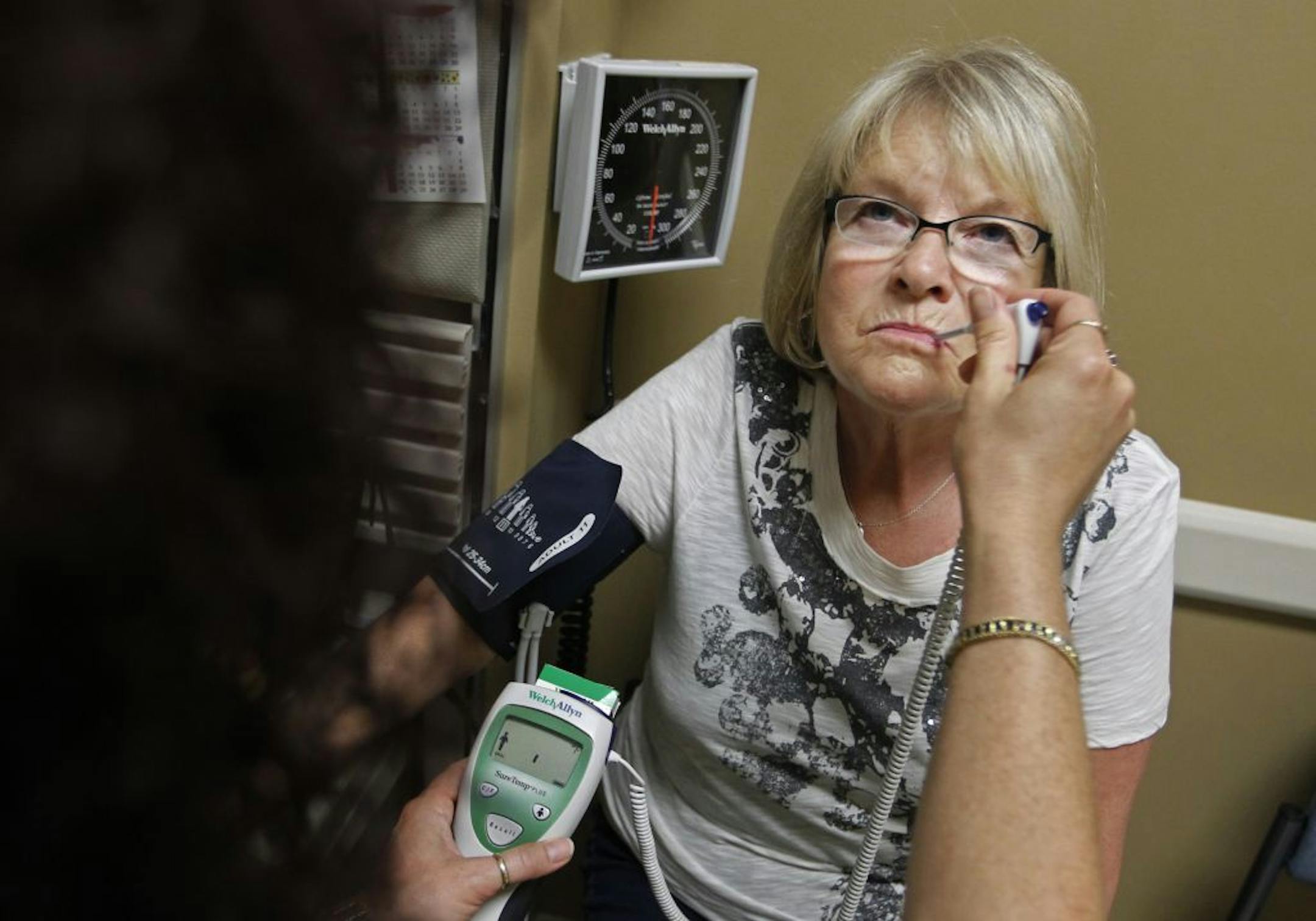 Without medical insurance after losing a job, Jeannie Gatlin had "intense" pain in her chest checked out Thursday at United Family Medicine in St. Paul.