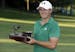 Jordan Spieth holds the trophy after winning the John Deere Classic golf tournament, Sunday, July 14, 2013, at TPC Deere Run in Silvis, Ill. Spieth de