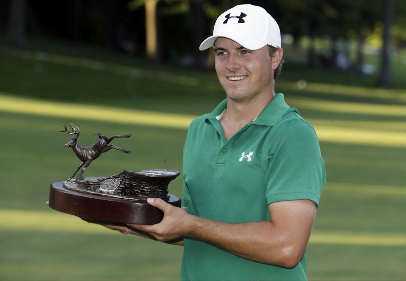 Jordan Spieth holds the trophy after winning the John Deere Classic golf tournament, Sunday, July 14, 2013, at TPC Deere Run in Silvis, Ill. Spieth defeated Zach Johnson and David Hearn on the fifth hole of a playoff.