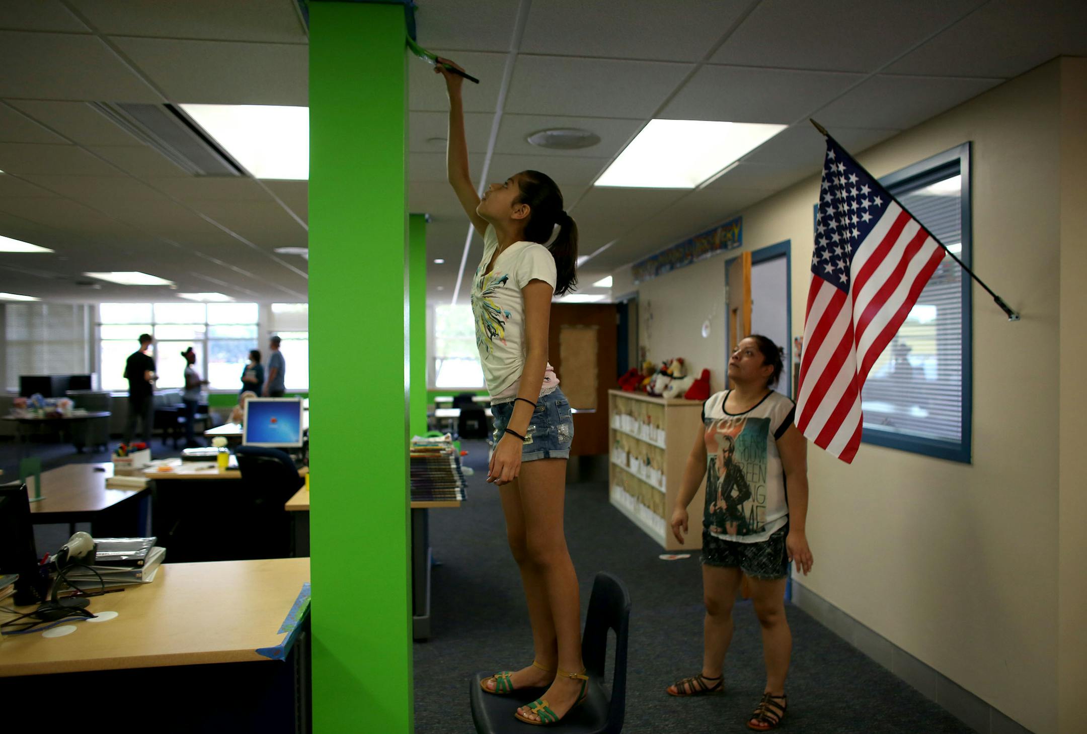 Yuridia Otero fifth grader, painted one of the columns in the media center. ] (KYNDELL HARKNESS/STAR TRIBUNE) kyndell.harkness@startribune.com During a day of "beautification" at Northport Elementary School in Brooklyn Park, Min., Tuesday, August, 19, 2014.