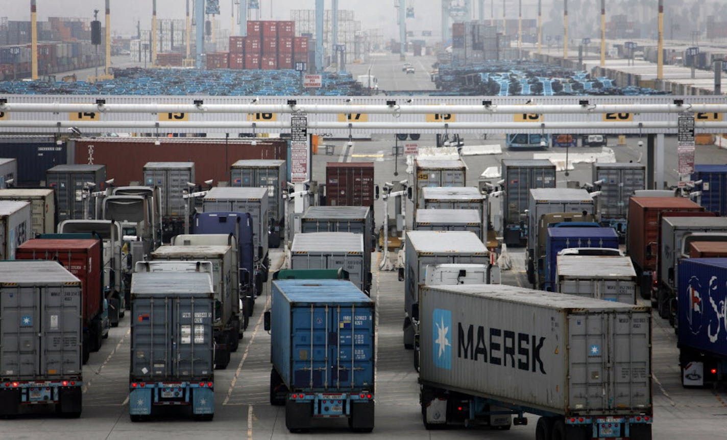 CORRECTS DATE OF PHOTO TO NOV. 6, 2014, AND UPDATES CAPTION - FILE - This Nov. 6, 2014, file photo shows trucks lined up at the Port of Los Angeles in Los Angeles. Labor strife on the West Coast waterfront isn't going to steal Christmas. With few exceptions, gifts and other holiday products made in Asia and shipped through U.S. sea ports already have made it to shelves, or are at distribution centers and ready to roll. Still, cargo is struggling to get through America's largest ports, which hand