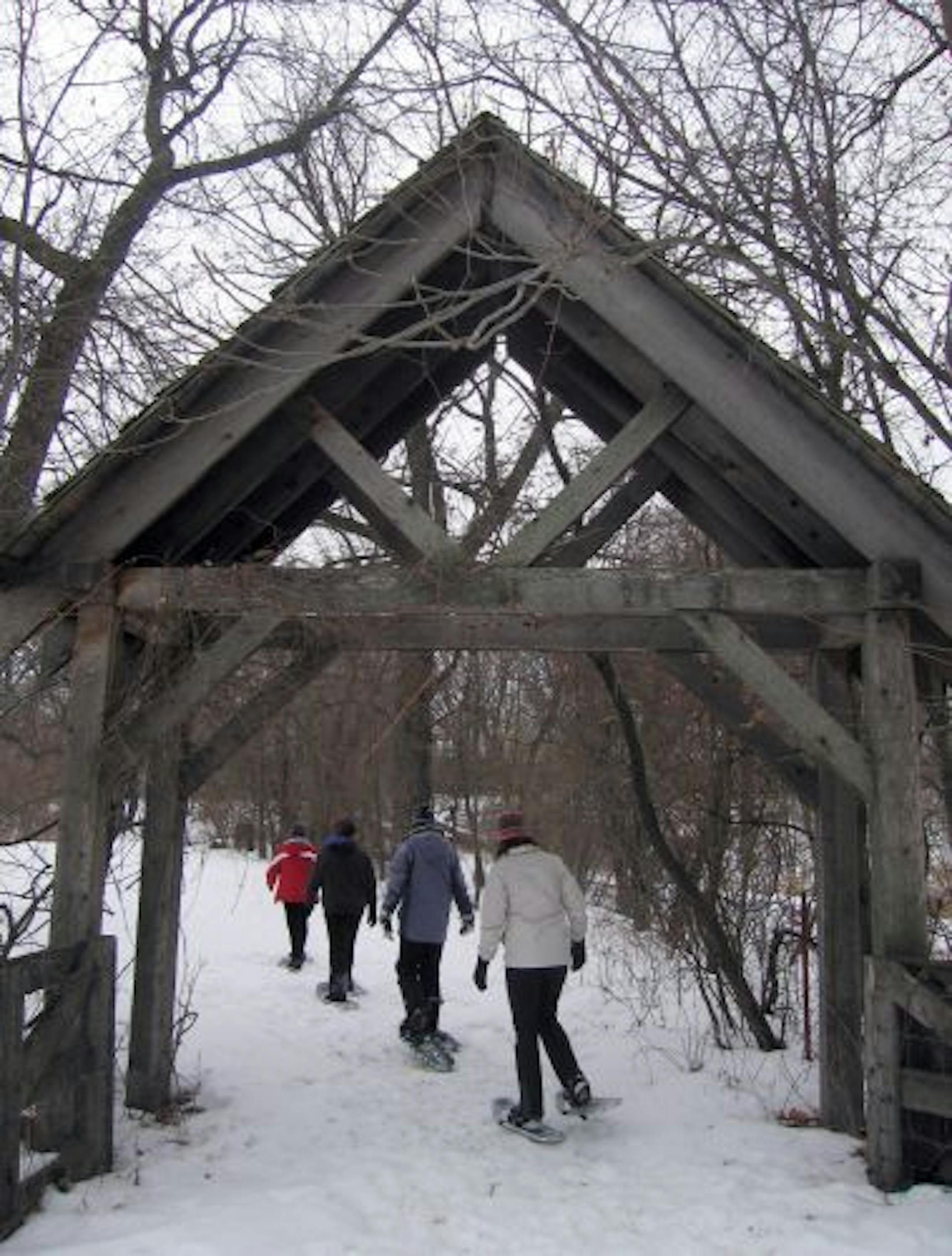 A fitness specialist leads snowshoers on an hourlong hike at Birdwing Spa. Exercise classes, healthful meals and pampering treatments such as facials and massages highlight trips to the in Litchfield, Minn., getaway.