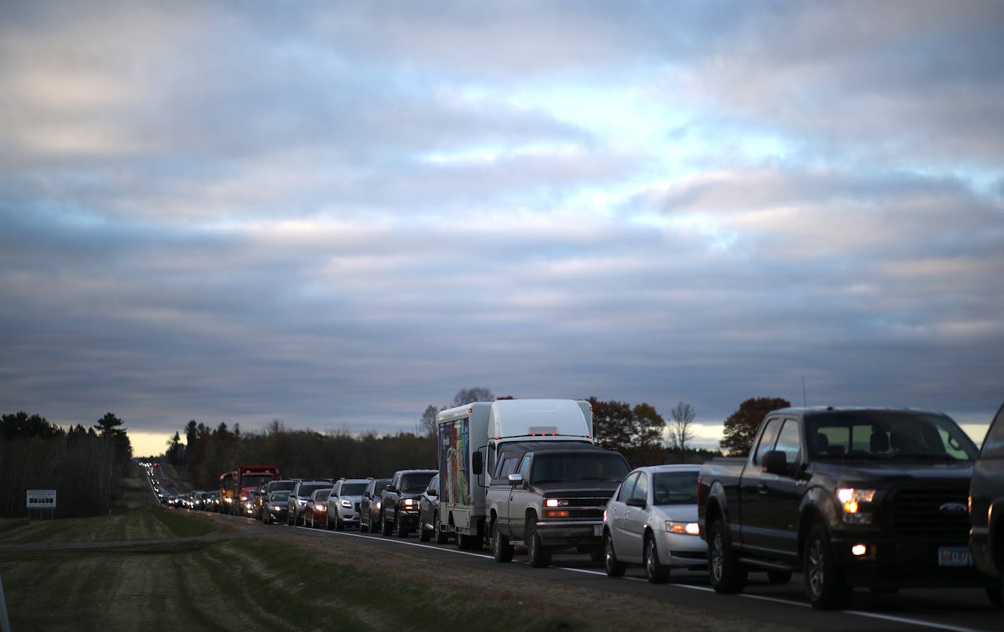 Cars fill Hwy. 25, north of Barron, Wis., as searchers arrived Tuesday morning to help in the Jayme Closs search.