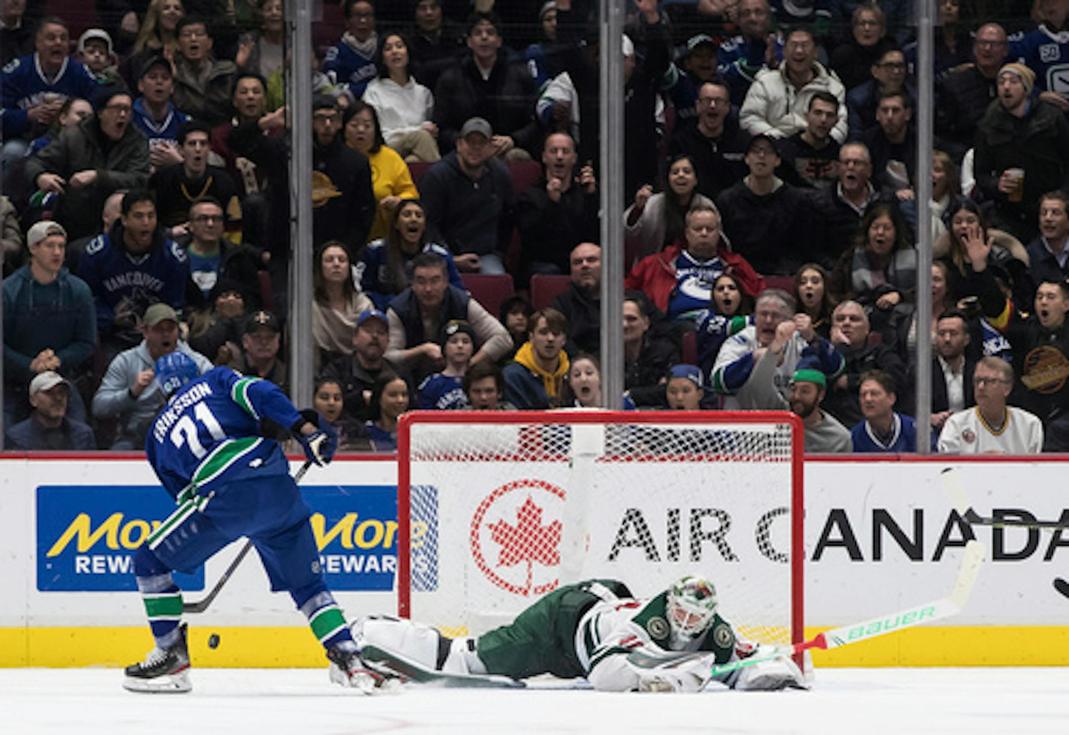 Minnesota Wild goalie Devan Dubnyk, right, stops Vancouver Canucks' Loui Eriksson, of Sweden, during the third period of an NHL hockey game Wednesday, Feb. 19, 2020, in Vancouver, British Columbia. (Darryl Dyck/The Canadian Press via AP)