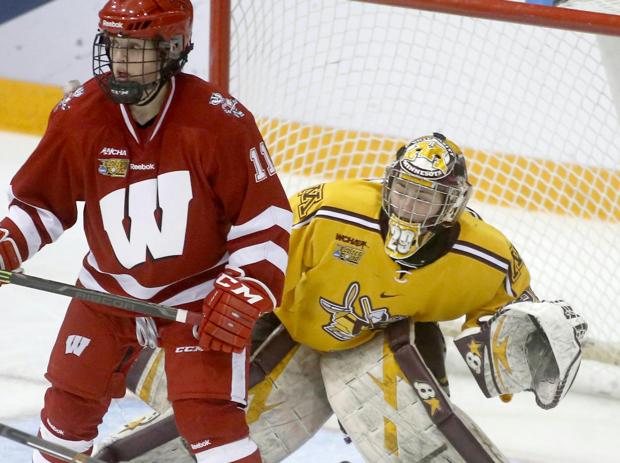 Minnesota goalie Amanda Leveille (29) peaks around Wisconsin's Sydney McKibbon (11) during the third period of the Gopher's 3-1 win over Wisconsin in the Women's NCAA Frozen Four hockey semifinals Friday, March 20, 2015, at Ridder Arena in Minneapolis.](DAVID JOLES/STARTRIBINE)djoles@startribune.com Women's NCAA Frozen Four hockey semifinals Friday, March 20, 2015, at Ridder Arena in Minneapolis.