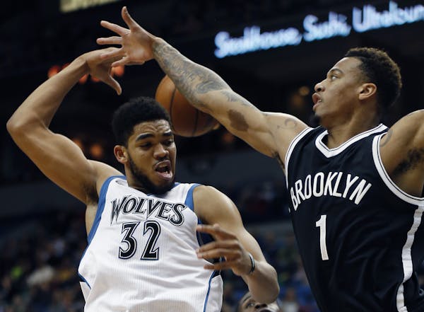 Timberwolves forward Karl-Anthony Towns passed behind himself against the defense of Nets forward Chris McCullough in the second half Saturday. The Ti