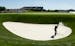 Rory McIlroy, of Northern Ireland, hits out of the bunker on the 17th hole during a practice round for the U.S. Open golf championship at Oakmont Coun