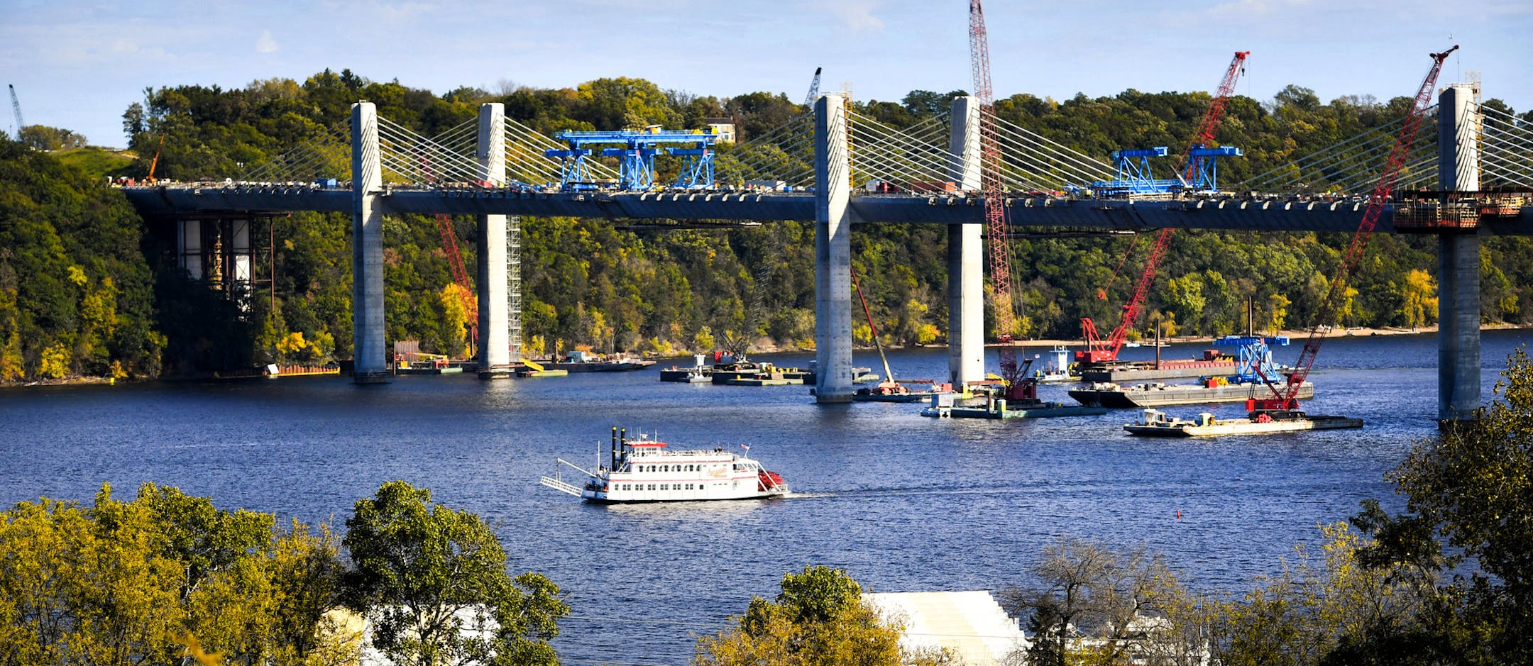 Water hazard: The Andiamo Showboat navigated past construction equipment at the new St. Croix River bridge on its way back to Stillwater.