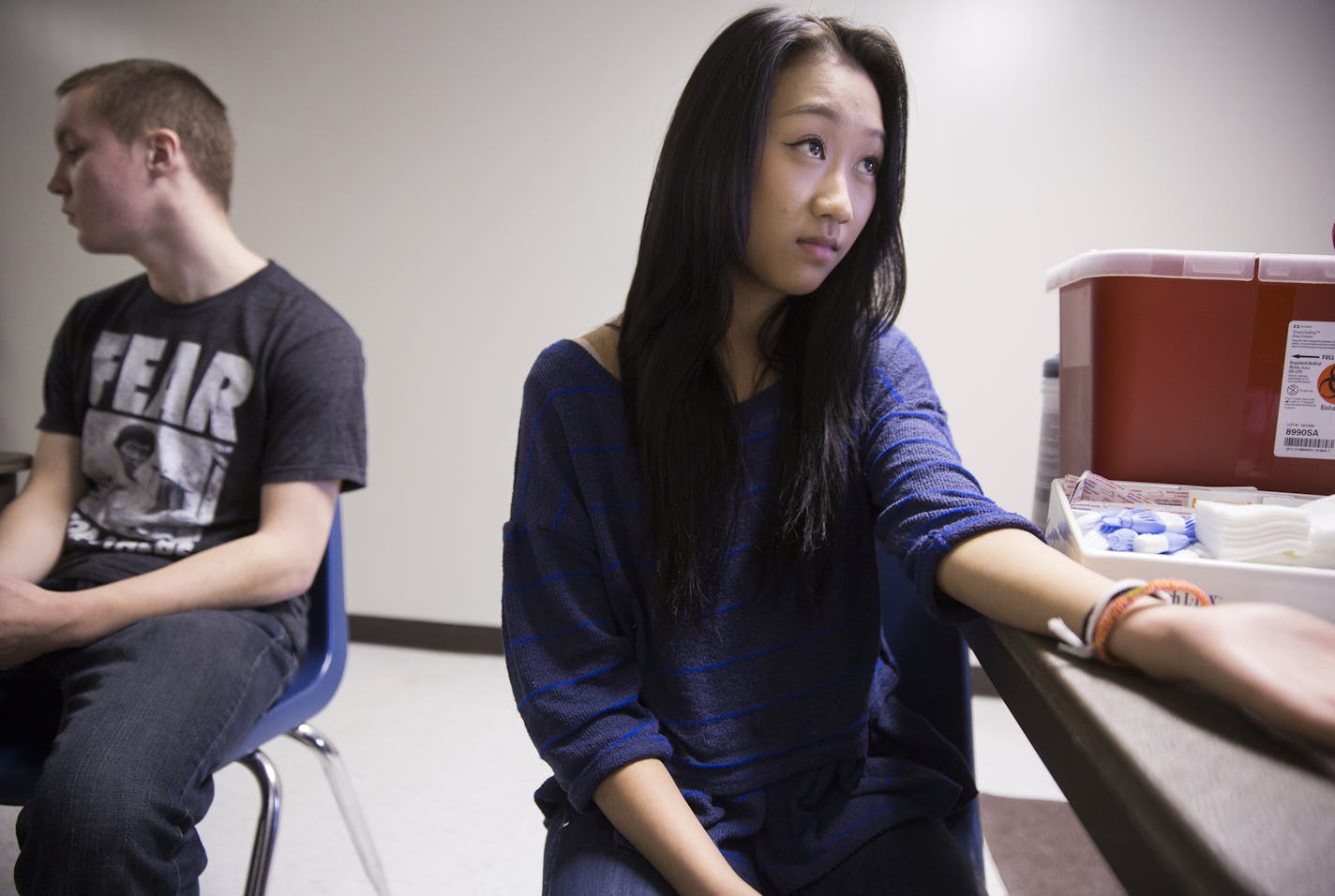Sophomore Joanna Vilay, 15, gets her finger pricked for cholesterol and blood sugar tests during a health screening by Allina Health at Champlin Park High School on Tuesday, January 20, 2015. ] LEILA NAVIDI leila.navidi@startribune.com / BACKGROUND INFORMATION: An innovative teen screening program at Anoka-Hennepin schools will be adding mental health screening questions to these health screenings in an attempt to identify and address growing levels of anxiety and depression.