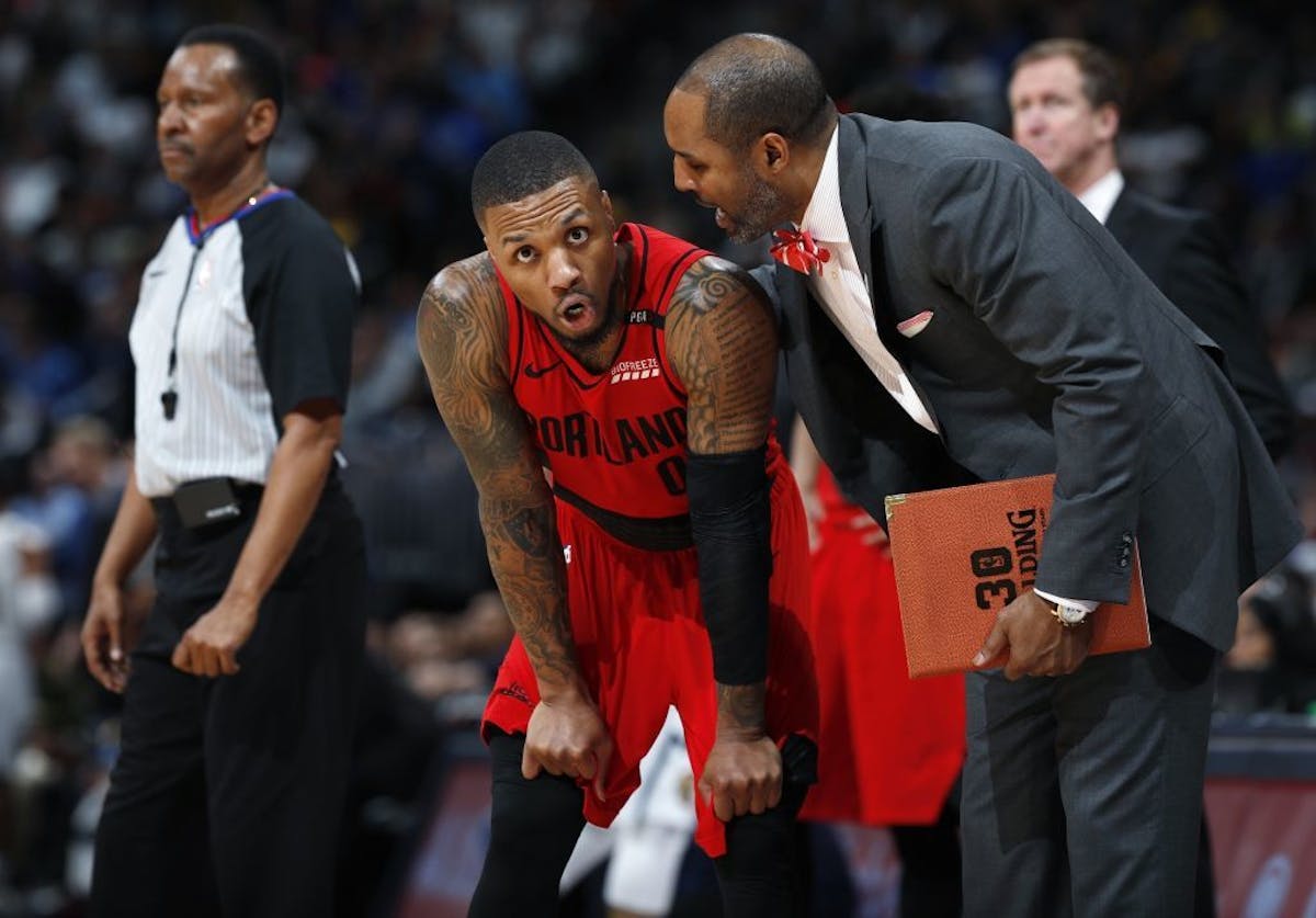 David Vanterpool, right, confers with Portland guard Damian Lillard during a break in the action in the second half of Game 2 of the team's NBA basket