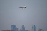 An American Airlines commercial airliner lands over the Minneapolis skyline at Minneapolis-St. Paul International Airport Tuesday, Dec. 14, 2021 in Minneapolis, Minn. Officials at the Minneapolis-St. Paul International Airport and the Transportation Security Administration are predicting a brisk Christmas travel season, despite the spread of COVID variants in Minnesota. ] ALEX KORMANN • alex.kormann@startribune.com
