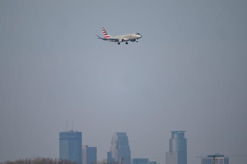 An American Airlines commercial airliner lands over the Minneapolis skyline at Minneapolis-St. Paul International Airport Tuesday, Dec. 14, 2021 in Minneapolis, Minn. Officials at the Minneapolis-St. Paul International Airport and the Transportation Security Administration are predicting a brisk Christmas travel season, despite the spread of COVID variants in Minnesota. ] ALEX KORMANN • alex.kormann@startribune.com