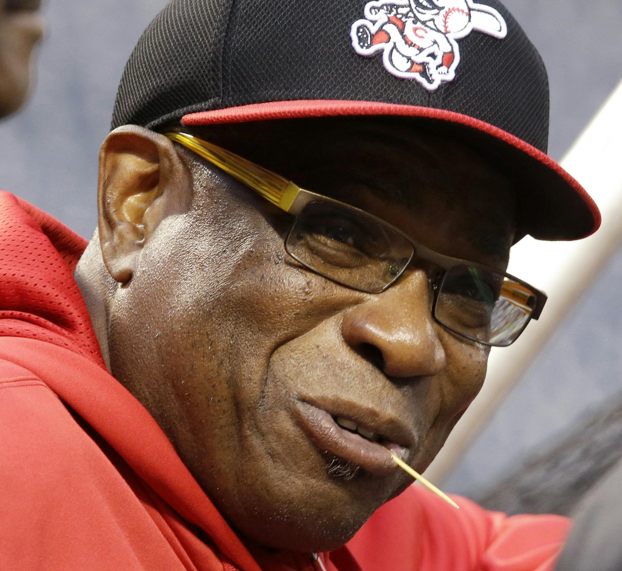 FILE - In this Sept. 30, 2013 file photo, then-Cincinnati Reds manager Dusty Baker talks with visitors behind the batting cage during the baseball team's workout in Pittsburgh. The Washington Nationals have announced they have hired Baker as their next manager. (AP Photo/Gene J. Puskar, File)