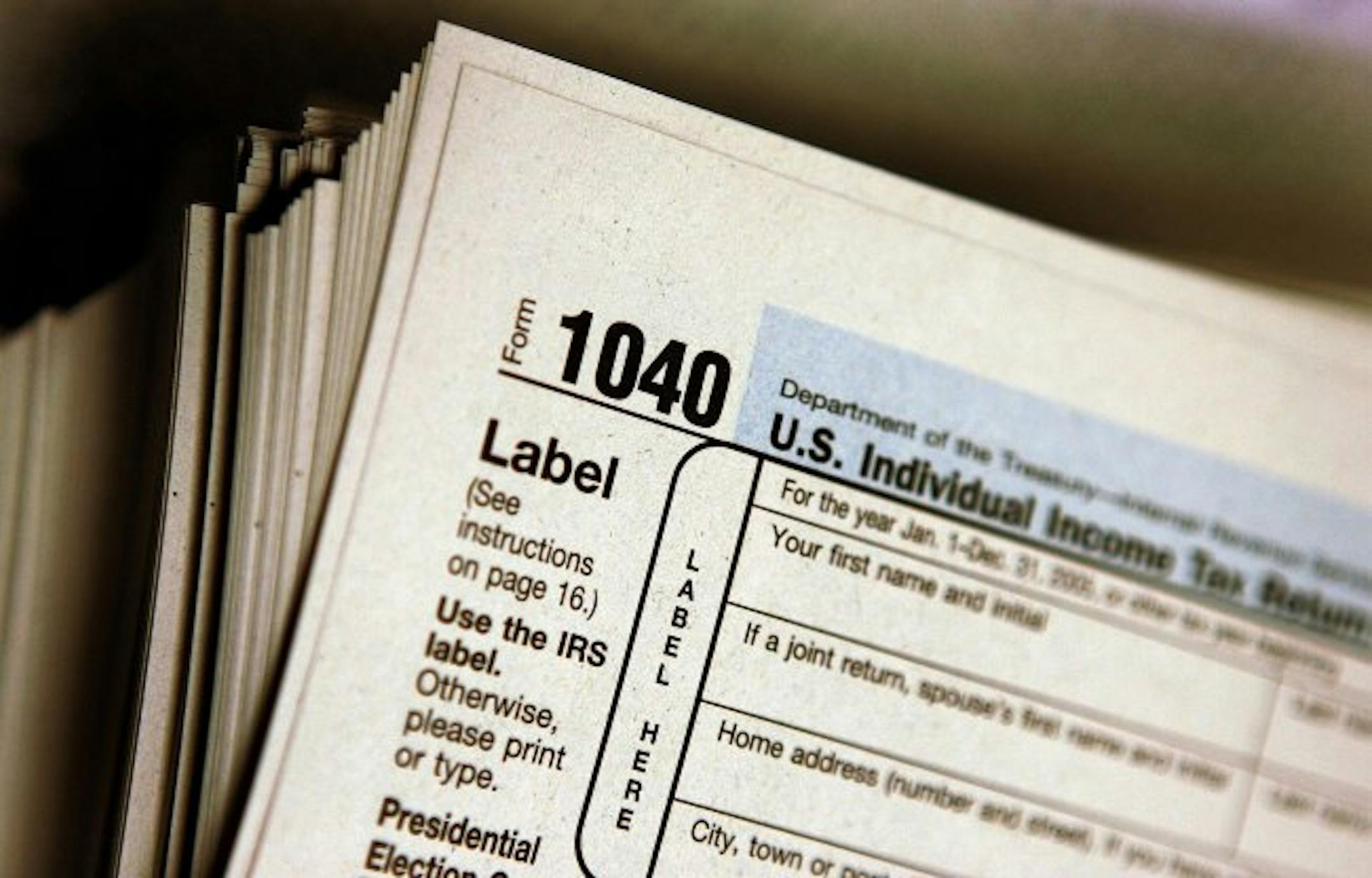 DES PLAINES, IL - MARCH 23: The top of a form 1040 individual income tax return for 2005 is seen atop a stack on the same at the Des Plaines Public Library March 23, 2006 in Des Plaines, Illinois. Americans are preparing for the income tax filing deadline next month whether using tax software, filing on the paper forms or using a tax preparer.