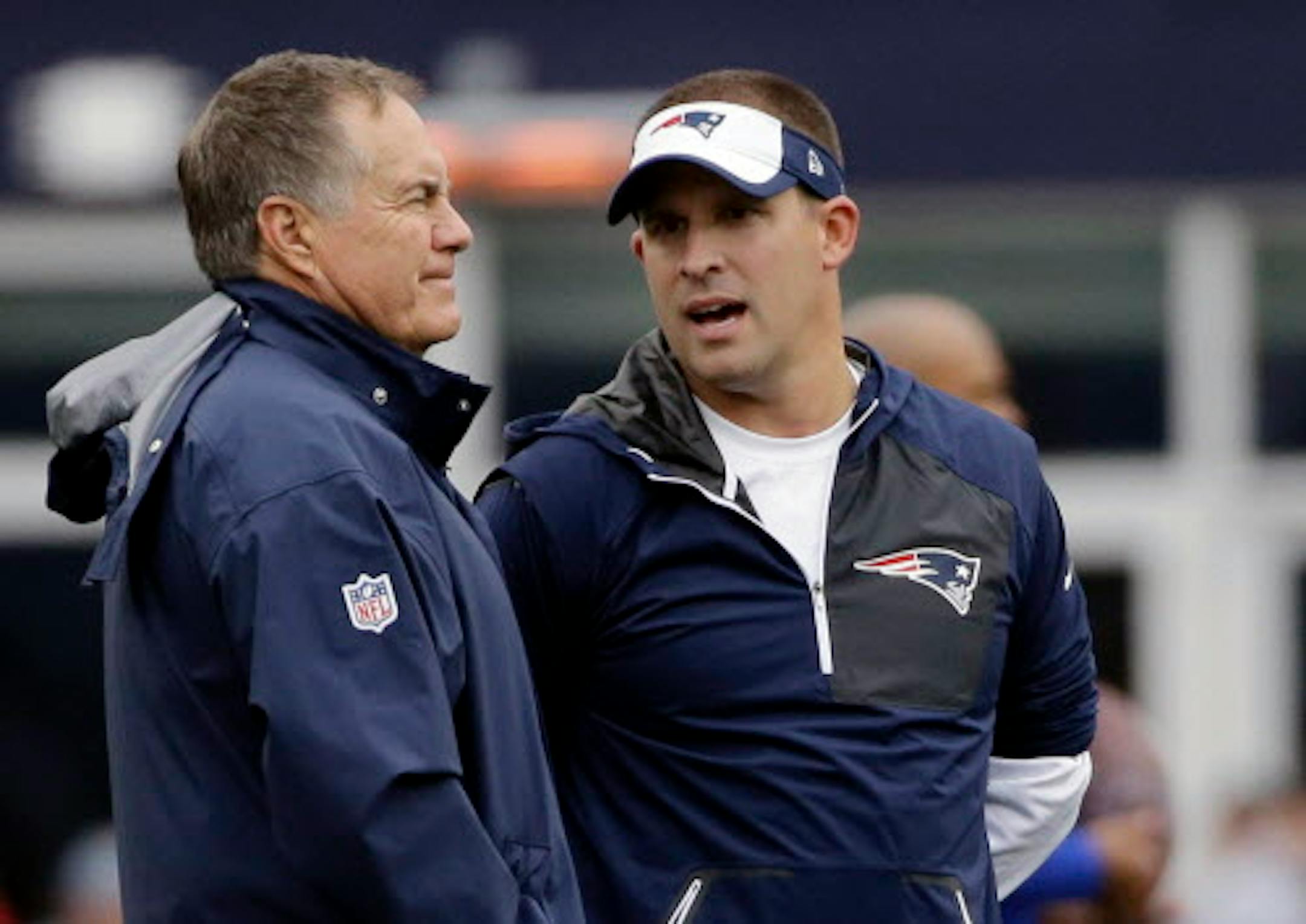 FILE - In this Oct. 2, 2016, file photo, New England Patriots head coach Bill Belichick, left, and offensive coordinator Josh McDaniels talk before an NFL football game against the Buffalo Bills in Foxborough, Mass. The Indianapolis Colts announced Tuesday, Feb. 6, 2018, that hey have hired Josh McDaniels as their new head coach. (AP Photo/Elise Amendola, File)