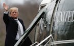 President Donald Trump waves as he boards Marine One as he leaves Walter Reed National Military Medical Center in Bethesda, Md., Friday, Jan. 12, 2018
