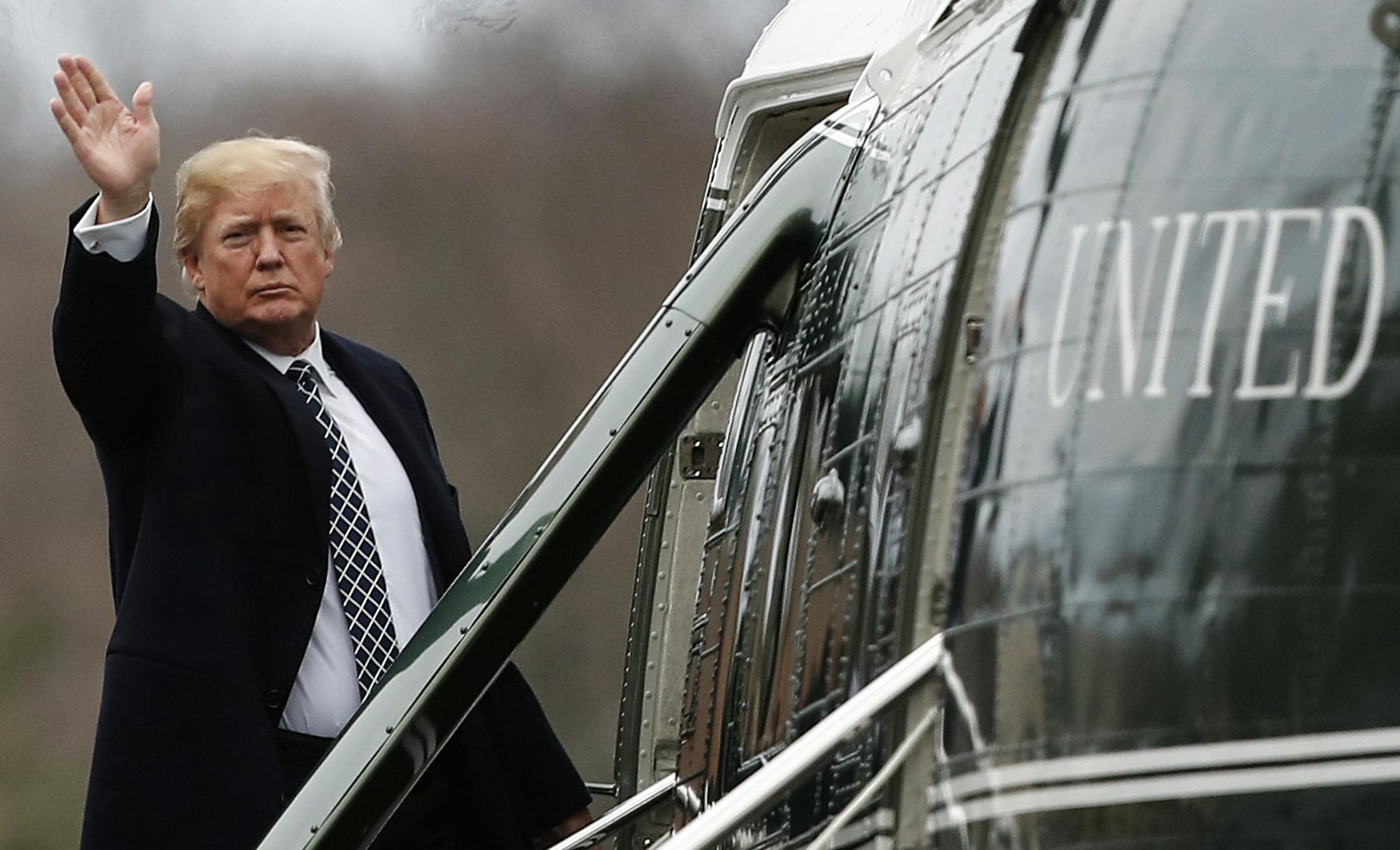 President Donald Trump waves as he boards Marine One as he leaves Walter Reed National Military Medical Center in Bethesda, Md., Friday, Jan. 12, 2018, after his first medical check-up as president. (AP Photo/Carolyn Kaster)