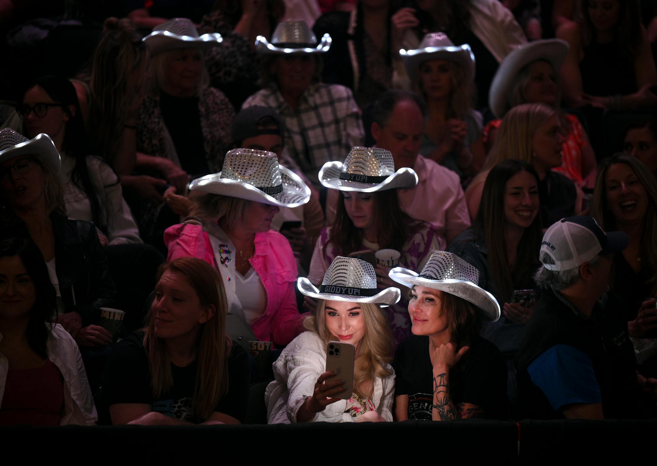 Fans take selfies before Shania Twain's performance Wednesday, May 17, 2023, at the Xcel Energy Center in St. Paul, Minn.