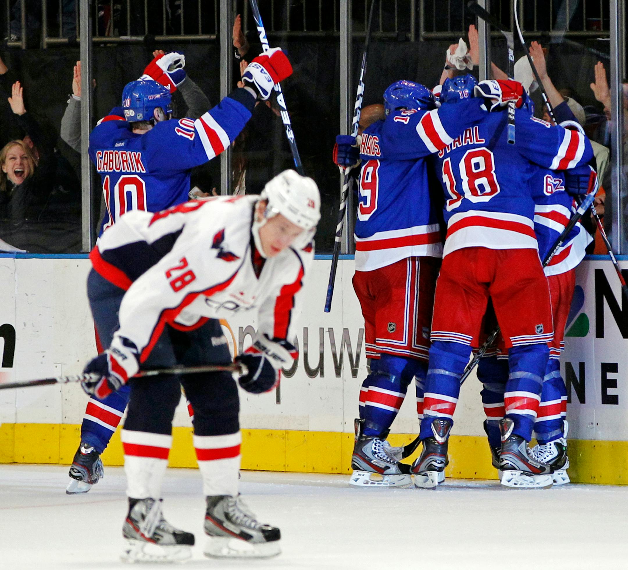 New York Rangers right wing Marian Gaborik (10), center Brad Richards (19), Marc Staal (18) and left wing Carl Hagelin (62), celebrate with Michael Del Zotto, obscured, as Washington Capitals left wing Alexander Semin (28) reacts after Del Zotto scored in the third period of Game 7 of their second-round NHL hockey Stanley Cup playoff series at Madison Square Garden in New York, Saturday, May 12, 2012. The Rangers won 2-1 and won the series 4-3. (AP Photo/Kathy Willens)