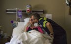 Tim Fink gives his wife, Molly, a kiss as she rests in her bed at Avamere Riverpark of Eugene in Eugene, Ore., July 17, 2017. The couple have used GoF