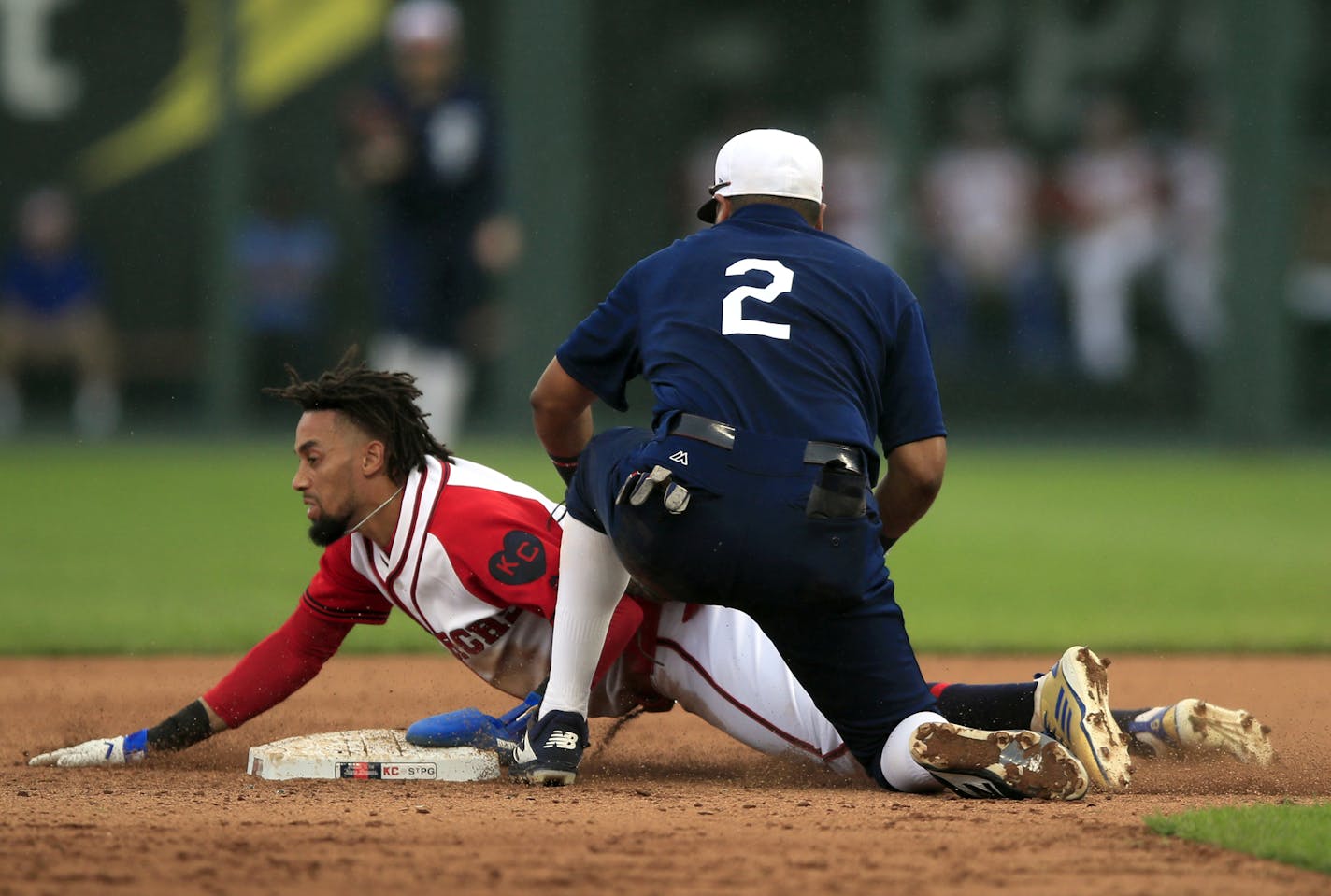 Kansas City Royals' Billy Hamilton, left, beats the tag by Minnesota Twins second baseman Luis Arraez (2) during the fourth inning of a baseball game at Kauffman Stadium in Kansas City, Mo., Sunday, June 23, 2019. (AP Photo/Orlin Wagner)