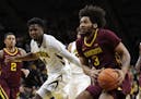 Minnesota forward Jordan Murphy (3) drives to the basket past Iowa guard Isaiah Moss, left, during the first half of an NCAA college basketball game, 