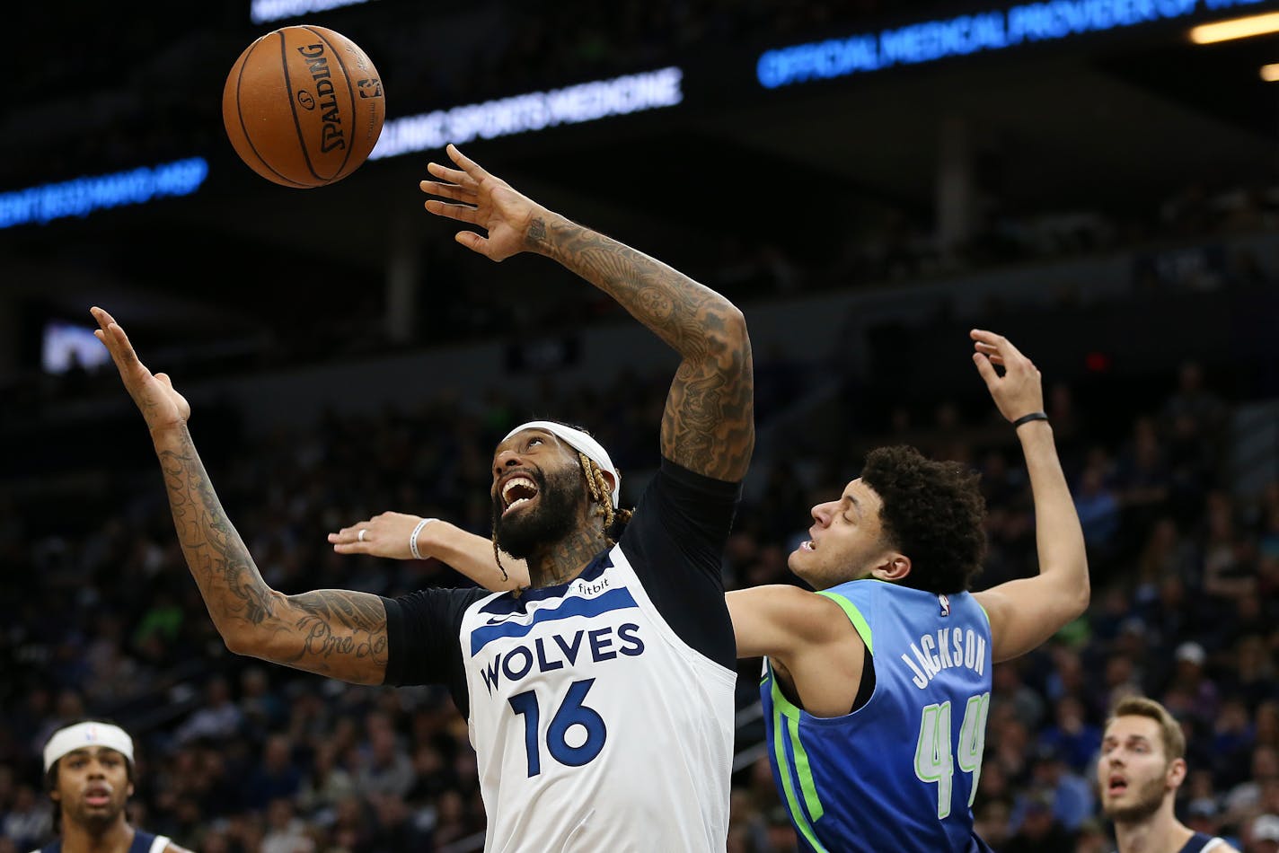 The Timberwolves' James Johnson goes up for a rebound against Dallas Mavericks' Justin Johnson