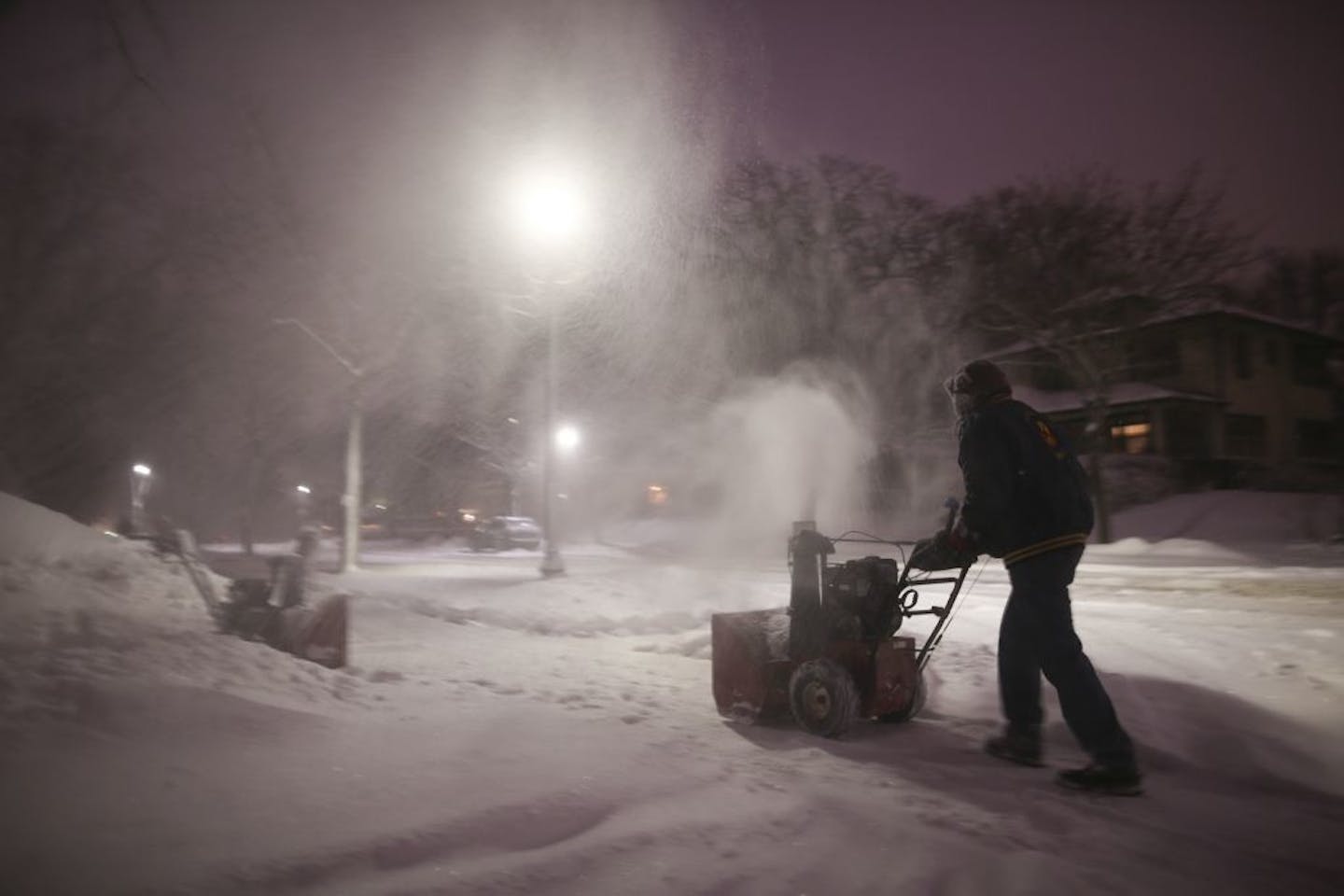 Jeff Gatesmith cleared the sidewalk along W. 46th St. in his south Minneapolis neighborhood even as snow continued accumulating into the evening Tuesday.