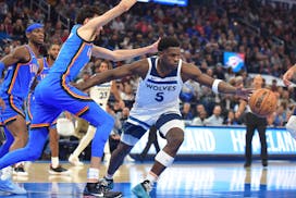 Timberwolves guard Anthony Edwards, right, lost the ball as he tried to get past Thunder forward Chet Holmgren, left, during the first half Tuesday in