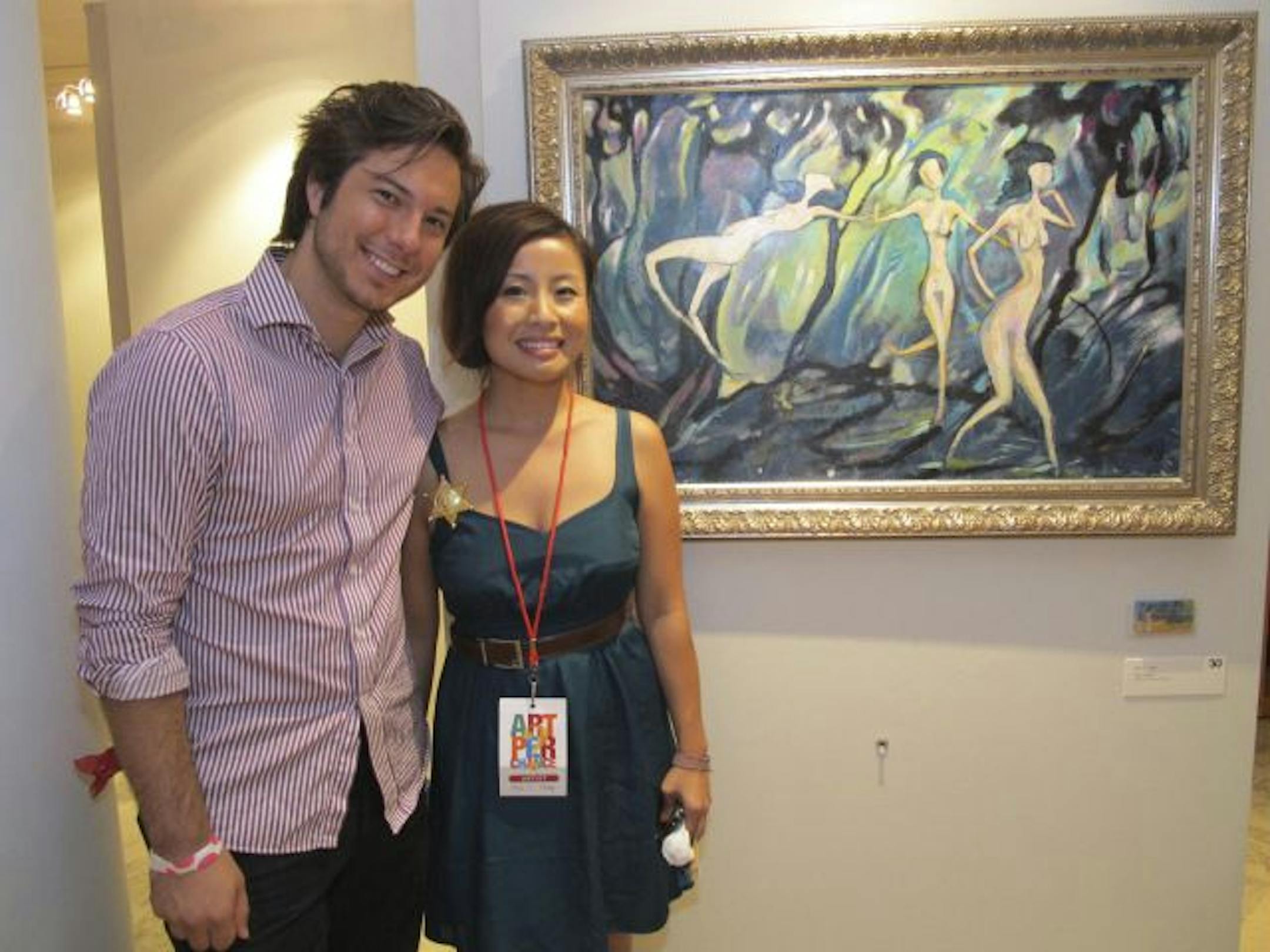 Austin O'Brion and Mai C. Vang with her painting "The Tiptoe."
