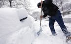 Joe Trusty clears snow from his car parked along street near his home on Friday, Feb. 24, 2017, in Rochester, Minn. Forecasters expected additional sn