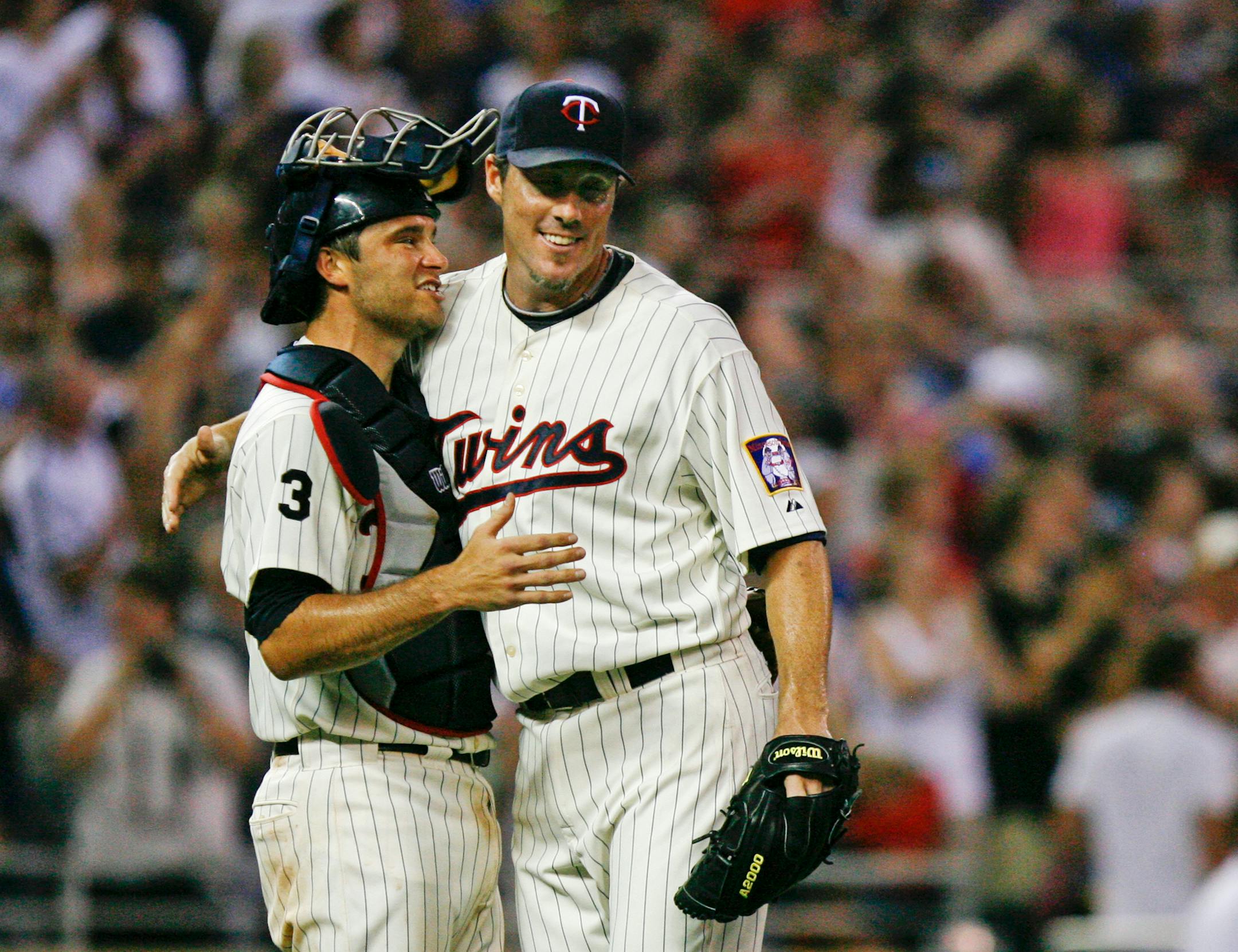 The Twins Joe Nathan is embraced by catcher Drew Butera after Nathan got the last out and the save in the Minnesota Twins 4-3 win over Kansas City Royals game at Target Field, July 16, 2011.