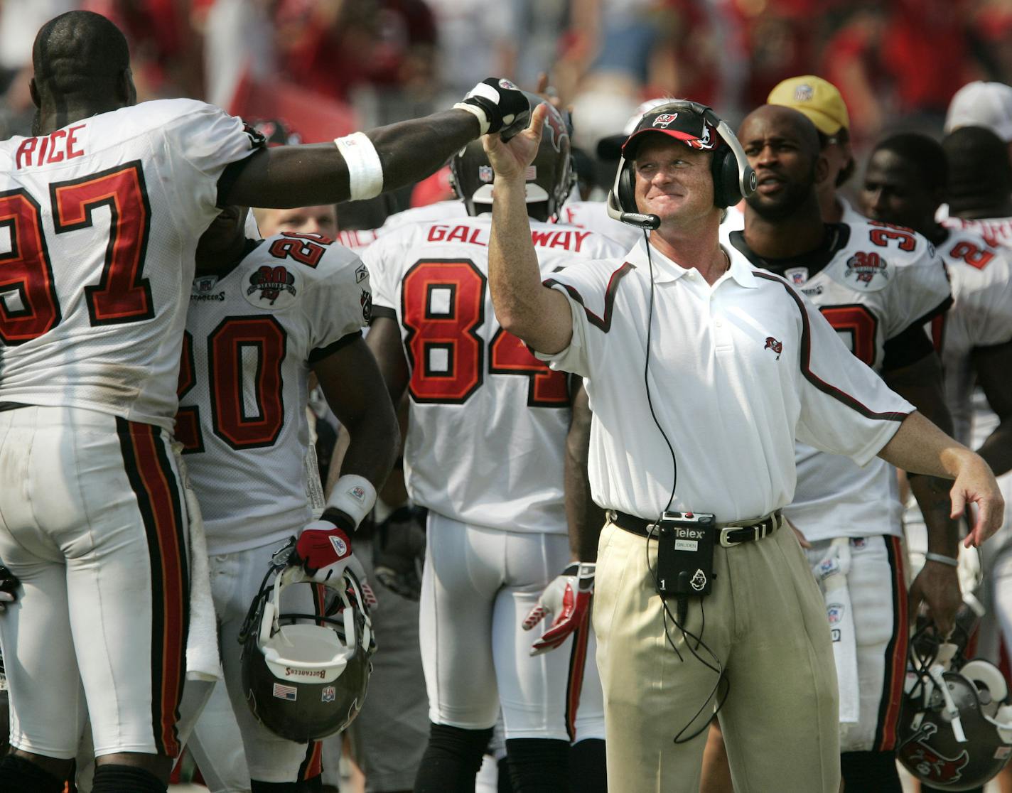 Tampa Bay Buccaneers coach Jon Gruden, right, celebrates with Simeon Rice (97) late in the fourth quarter against the Buffalo Bills on Sunday, Sept. 18, 2005, in Tampa, Fla. The Buccaneers defeated the Bills, 19-3. (AP Photo/Scott Audette) ORG XMIT: TPS110