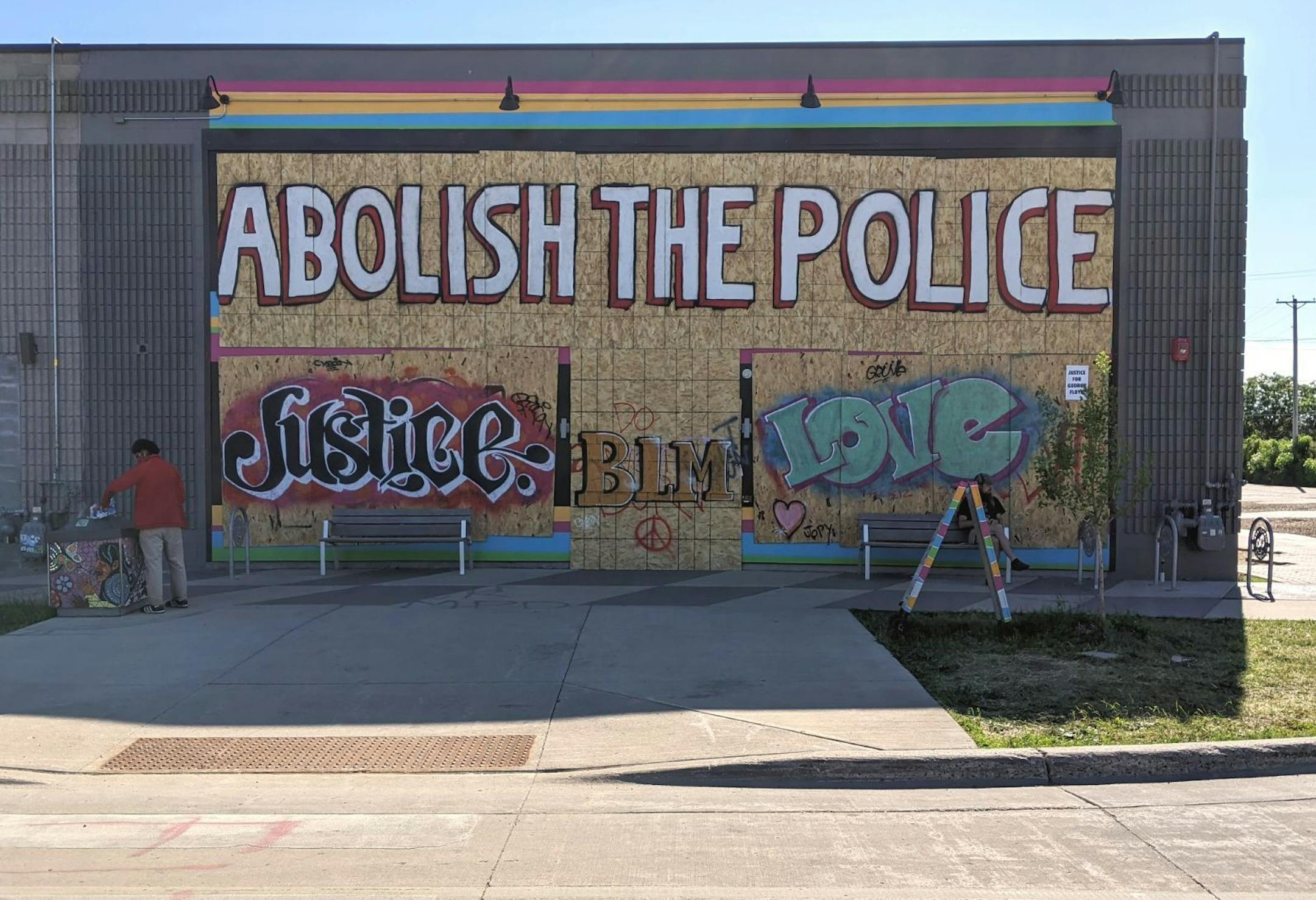 The giant mural across Moon Palace's (3032 Minnehaha Ave.) large, glass storefront calls for change in light of George Floyd's death while in police custody.