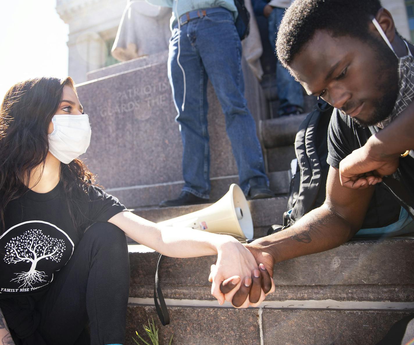 (Left) Brayleigh Keliin and Joe Carter, the protest organizers, joined hands during nine minues of silence in honor of George Floyd in Duluth, MN on Saturday. Floyd was suffocated for nine minutes before dying. ] ALEX KORMANN • alex.kormann@startribune.com Over a thousand people marched through the streets of Duluth, MN on May 30, 2020 to protest the death of George Floyd.