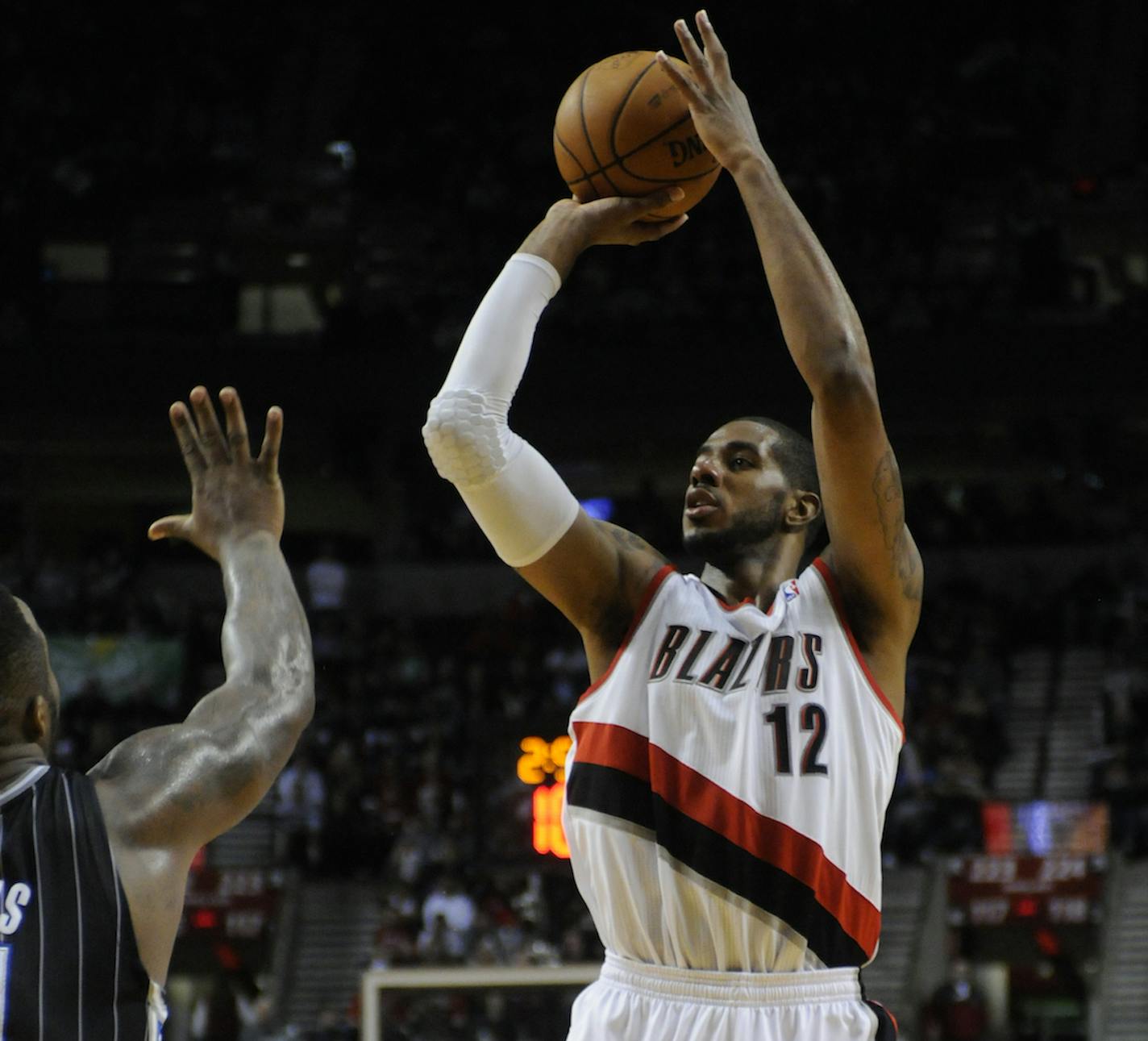 The Portland Trail Blazers' LaMarcus Aldridge (12) shoots against the Orlando Magic during an NBA basketball game in Portland, Ore., Wednesday Jan. 8, 2014. (AP Photo/Greg Wahl-Stephens)