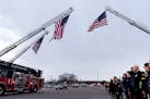 Citizens joined police officers, firefighters and other first responders to greet a planned processional for firefighter and paramedic Adam Finseth, w