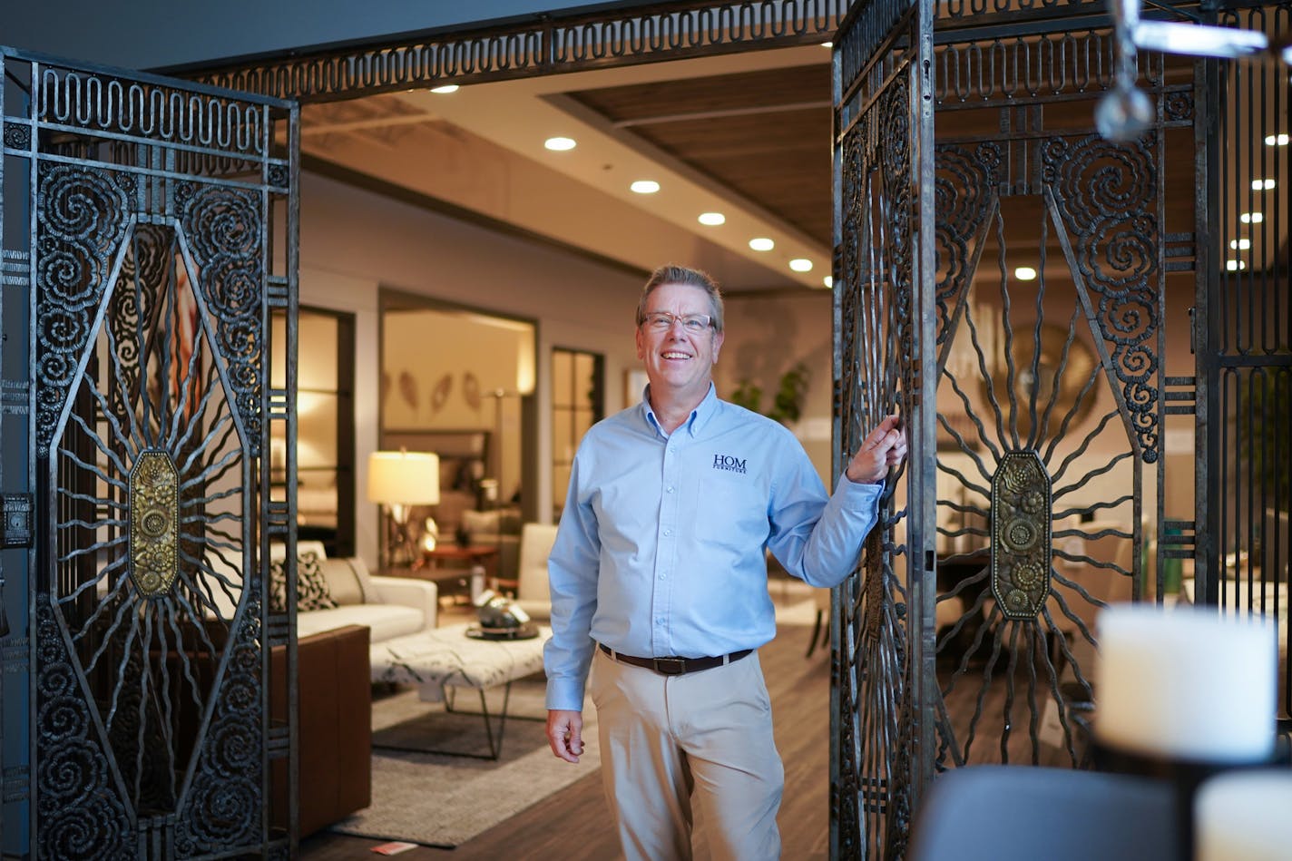 HOM chief executive Rod Johansen is in the Gabberts part of the retailer's new Bloomington megastore. The custom forged iron gates were originally in the Foshay Tower. (GLEN STUBBE/Star Tribune)