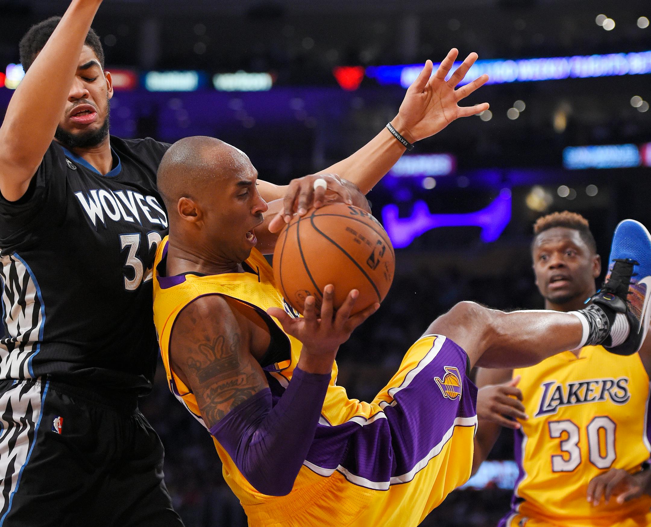 Lakers forward Kobe Bryant came down with a rebound while under pressure from Timberwolves center Karl-Anthony Towns. Bryant scored 38 points in the game.
