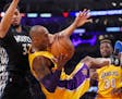 Lakers forward Kobe Bryant came down with a rebound while under pressure from Timberwolves center Karl-Anthony Towns. Bryant scored 38 points in the g