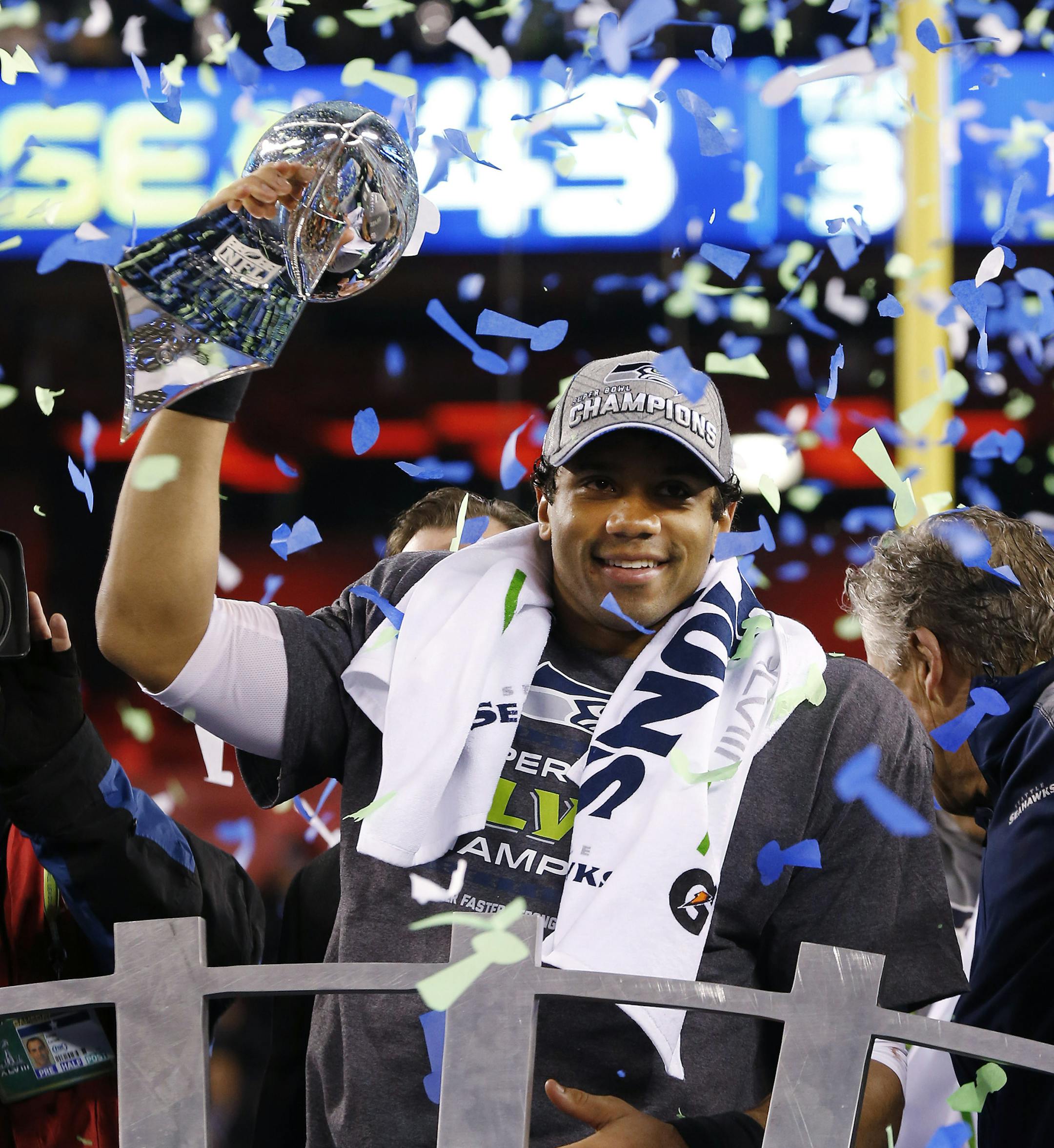 FILE - In this Feb. 2, 2014, file photo, Seattle Seahawks quarterback Russell Wilson holds up the Lombardi Trophy after beating the Denver Broncos 43-8 in the NFL Super Bowl XLVIII football game at MetLife Stadium in East Rutherford, N.J. Itís never been harder than in this salary-cap, free-agency era of parity for an NFL team to win two Super Bowls in a row, something the Seahawks will achieve Sunday if they can beat the New England Patriots, the last club to do it, a decade ago.(AP Photo/