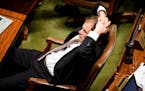 Representative Paul Marquart, DFL, Dilworth, stretched during a long floor debate of the Omnibus Environment bill on the last day of session. The Hous
